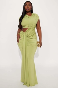 Detail of the light green ruched dress featuring a side waist cut-out and sleek fabric texture