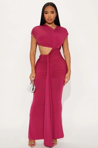 Detail of fuchsia asymmetrical evening dress featuring ruching and waist cut-out