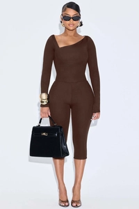 Detail of dark brown slim fit two-piece set with asymmetric neckline and knit texture