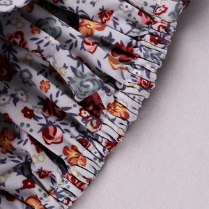 Detail of floral print fabric with elastic gathered smocking and precise stitching