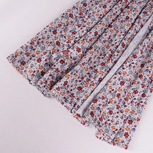 Close-up detail of light purple floral fabric with pleated texture and vintage pattern