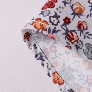 Detailed close-up of floral print fabric with high-quality single needle rolled hem