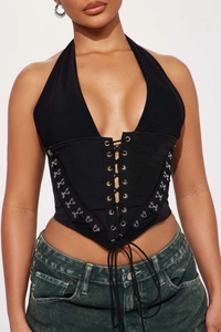 Detail of black corset halter top featuring front lace-up and metal hook closure design