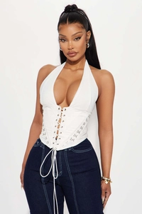 Detailed view of white halter corset top featuring cross lacing and silver metal rings