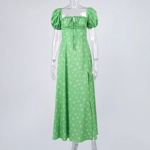 Detail of floral green dress featuring puff sleeves and square neckline with drawstring