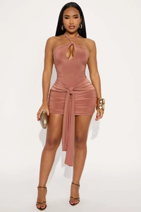 Detail of halter neck cutout and crisscross tie waist on a slim fit party dress