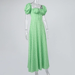 Detailed view of green floral dress featuring square neck design and puff sleeves
