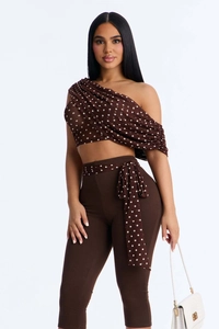 Detail of dark brown polka dot off-shoulder mesh top and high waist cropped pants set