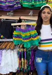 Detail view of multi-layer sequined Mardi Gras ruffles in purple, gold, and green