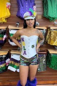 Detail view of Mardi Gras sequin outfit with NOLA corset and feathered white hat