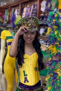Detailed shot of Mardi Gras corset top with NOLA letters and colorful feather boa