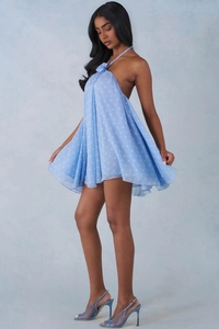 Detail of light blue polka dot mesh mini dress featuring 3D flower halter neck and open back