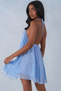 Detail of light blue polka dot summer dress showing the halter backless design and light fabric