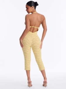 Pale yellow floral lace jumpsuit with halter neck and open back design for summer