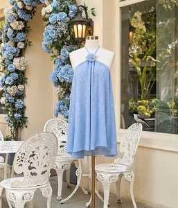 Detail of light blue polka dot halter dress with handcrafted 3D floral neckline ornament