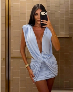Detail of light blue sleeveless dress with deep V-neckline and waist knot ruching