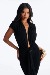 Detail showing deep V-neck and twist knot texture on black short sleeve jumpsuit