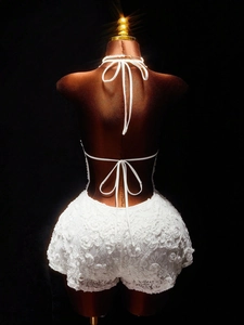 Detailed back view of white floral lace romper with adjustable criss-cross tie straps