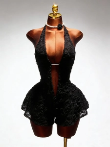 Detailed view of the 3D rosette lace texture on this sexy black halter jumpsuit