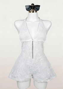 Close-up of intricate floral lace texture on a white halter neck V-neck romper