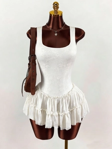 Close-up of white floral lace sleeveless dress with elegant tiered ruffle layers