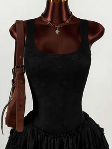 Detail of floral lace texture and tiered ruffle hem on this black sleeveless dress