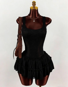 Detail of black lace bodice and tiered chiffon ruffle hem on a fitted summer dress