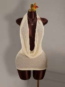 Sleeveless backless cream knit halter mini dress with deep V-neck and polka dot texture