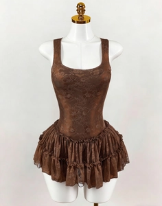Macro shot of coffee brown floral lace details and layered ruffle hem on the dress