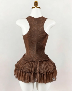 Detail of dark brown lace ballet dress featuring tiered ruffles and racerback with zipper