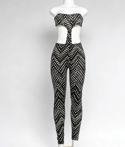 Detail showing checkered print and cutout waist design of a slim fit halter jumpsuit