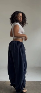 Detail view of wide-leg sweatpants with drawstring waist and side ruching detail