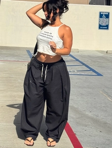 Detail view of the black drawstring waist on high-waist loose wide leg casual trousers
