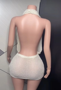 Detailed back view of white knit halter neck dress showing open back and mesh texture
