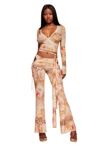 Detail of V-neck wrap top and flared pants in leopard floral print chiffon fabric