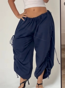 Detail of navy blue wide-leg cargo pants with elastic waist and adjustable drawstrings