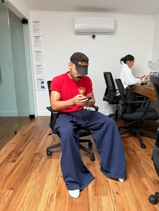 Detail of baggy wide-leg casual pants and red t-shirt in an oversized urban streetwear style