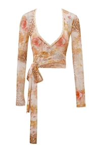 Close-up of V-neck wrap top with floral paisley print and delicate lace trim detail