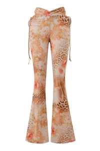 Detail of high-waist flared pants featuring leopard print and orange floral patchwork