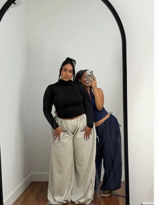 Mirror selfie showing loose drawstring wide leg sweatpants in grey and navy blue fabric