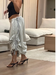 Detail view of light grey wide-leg lounge pants with unique side drawstrings and ruching