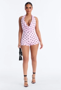 Detail of pink polka dot halter neck romper with sexy open back and slim fit design