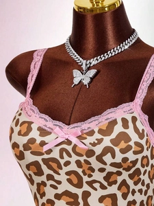 Close-up of sparkling hollow butterfly pendant with white zircon on silver Cuban link chain
