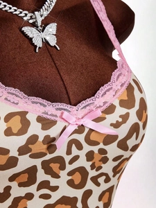 Detail of leopard print camisole featuring pink lace trim and a satin bow decoration
