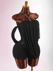 Detail of elegant black strapless mini dress with pleated lace and cascading ruffles