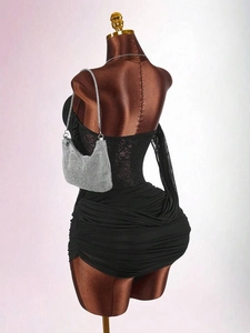Macro shot of back sheer lace detail and ruched design on black bodycon party dress