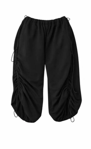 Detail of adjustable ruched side drawstrings on these black wide leg street pants