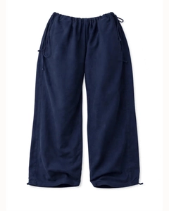 Detail of navy blue drawstring waist and adjustable cuffs on wide-leg casual pants
