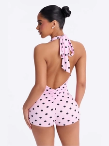 Pink polka dot halter romper with back tie and ruched detail for a summer look