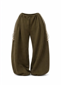 Detail view of olive green wide-leg trousers featuring drawstring waist and rope accents